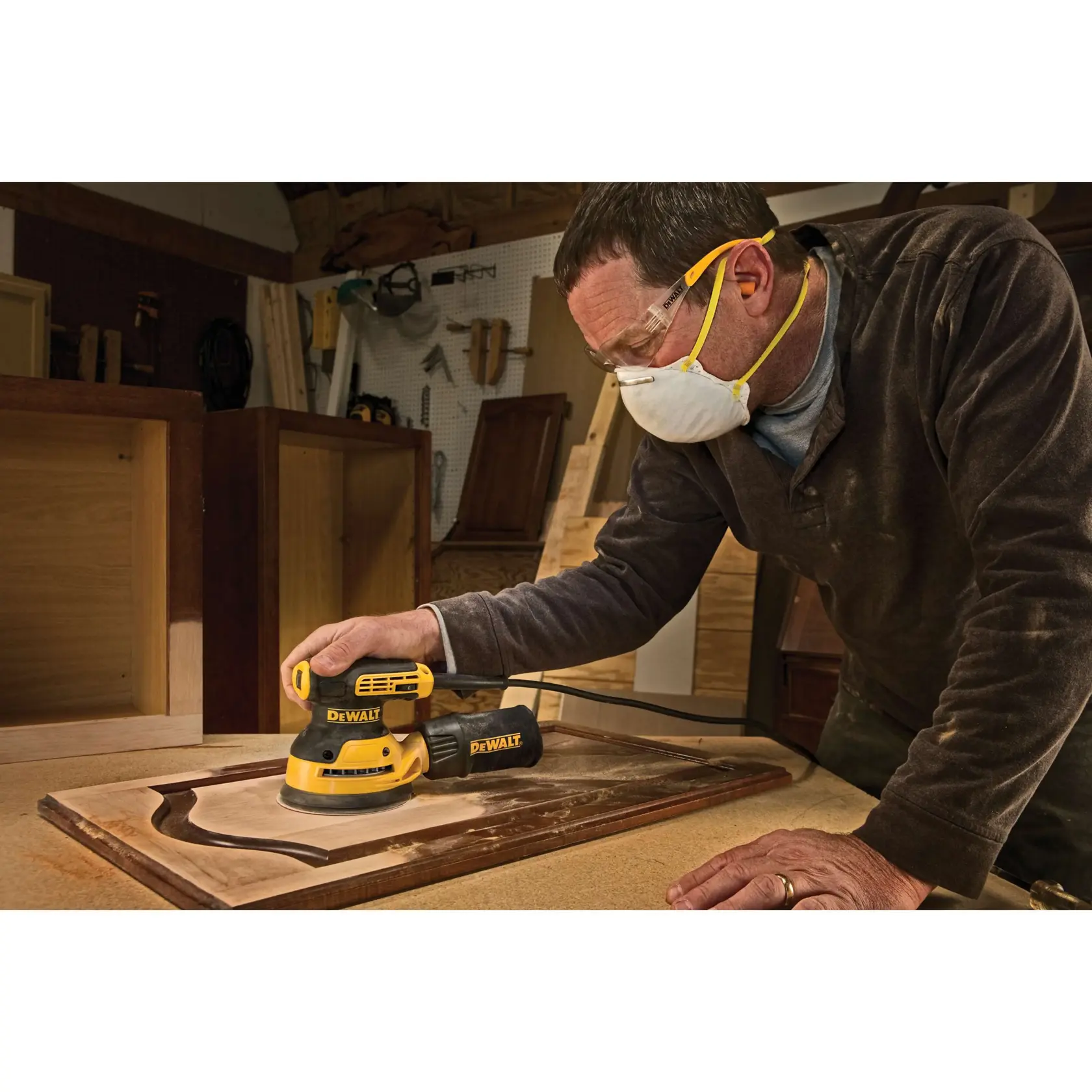 A DEWALT electric sander with a dust collection bag, shown in black and yellow color, with the text 'REDUCED VIBRATION WITH SEPARATE COUNTERWEIGHT' displayed below.