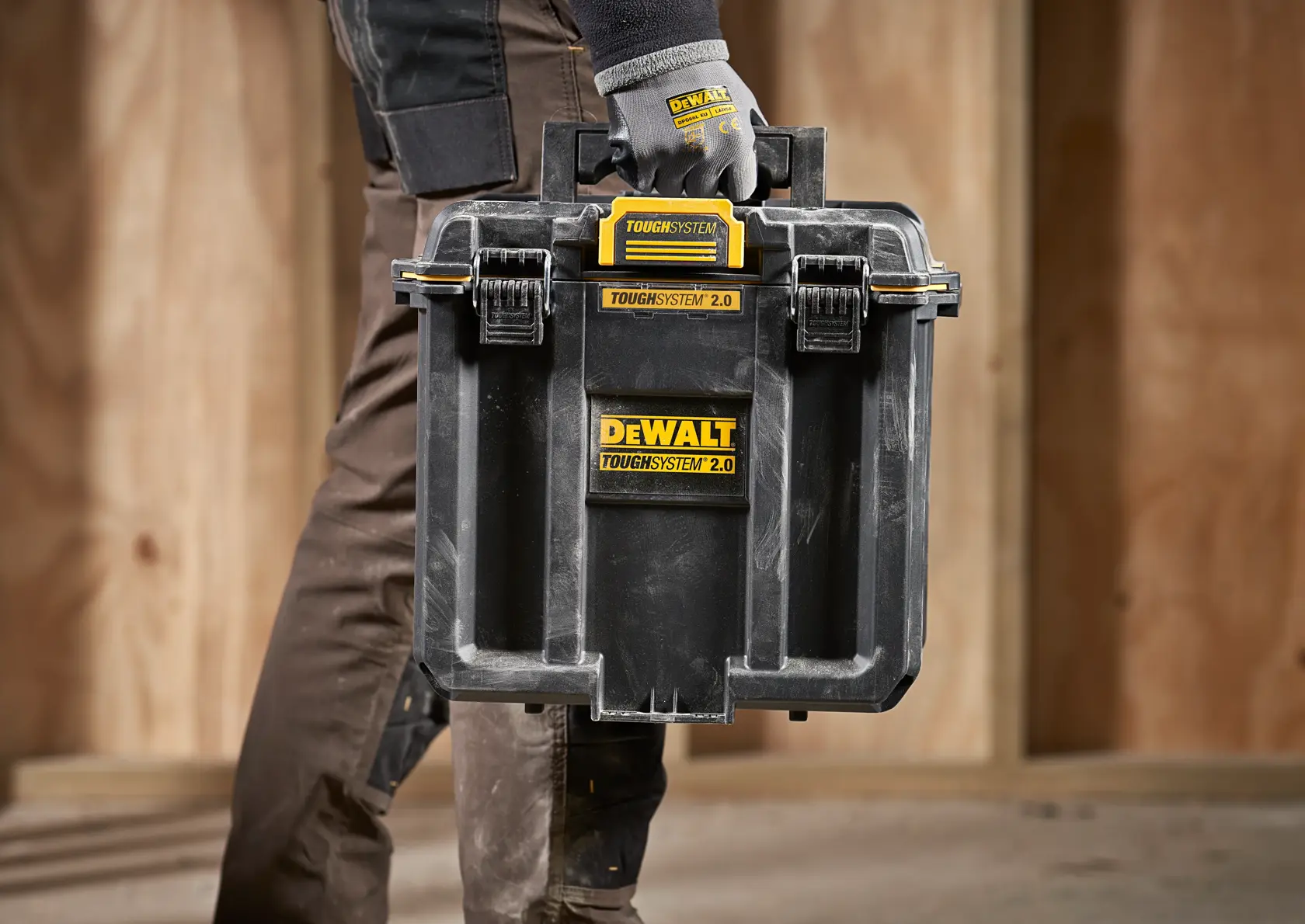 DEWALT ToughSystem 2.0 promotional graphic with the slogan 'Storage Built to Handle It' in large, bold yellow lettering on a dark, textured background.