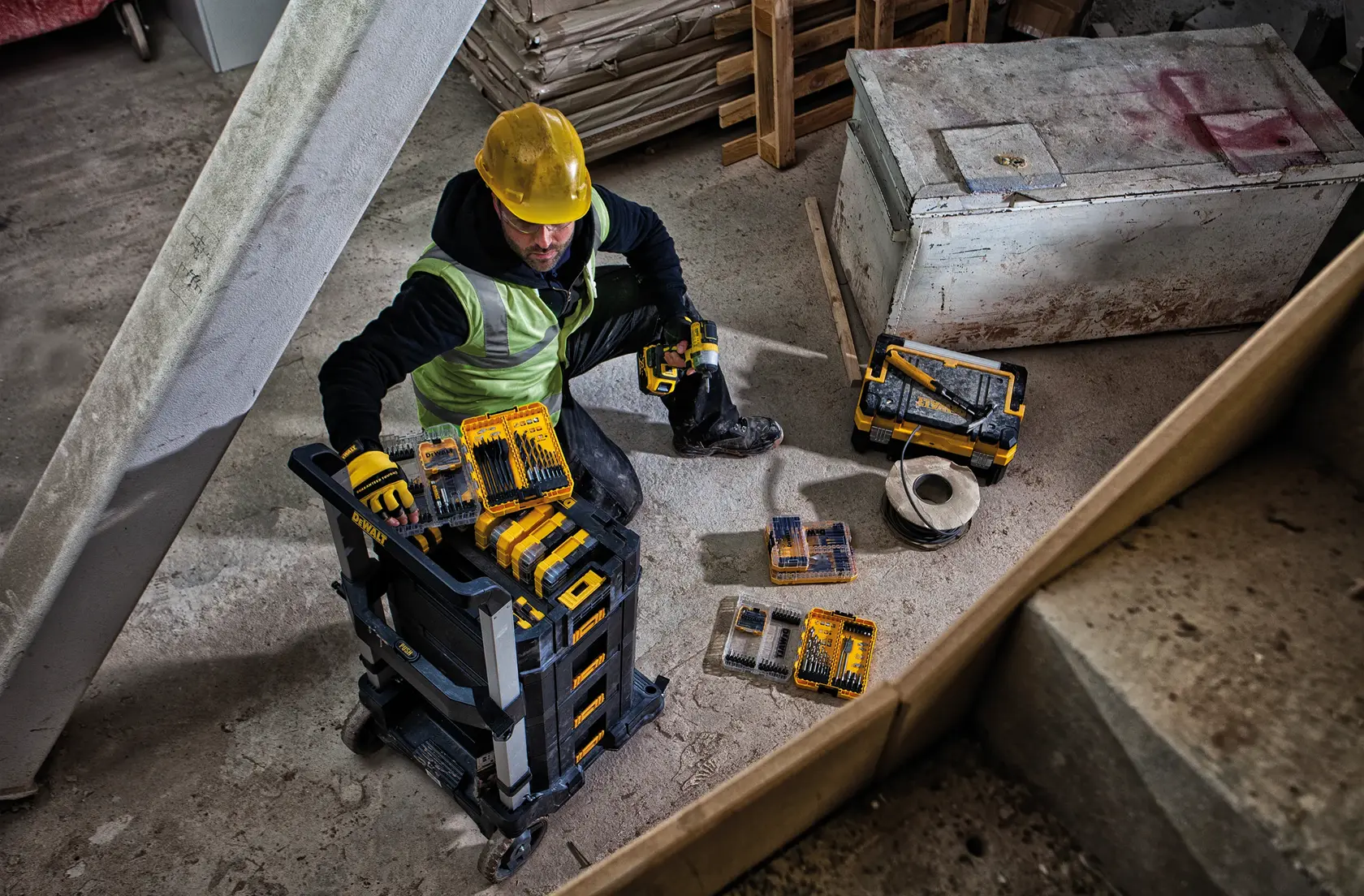 A DEWALT rolling trolley platform with a black plastic base, silver metal frame, and four caster wheels. The platform features locking mechanisms and a raised handle for transporting heavy items.